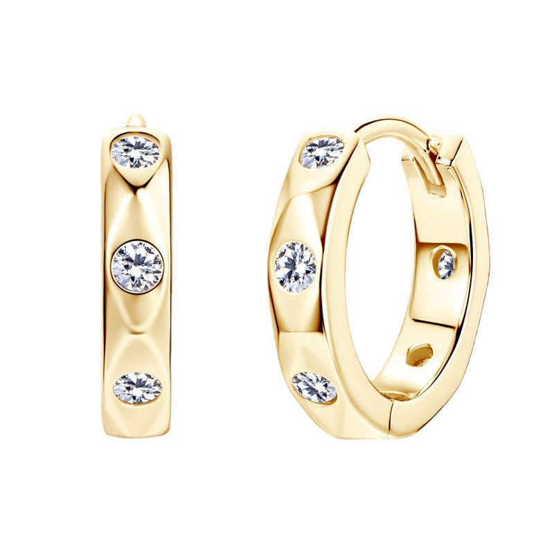 Product photography of sterling silver huggie earrings with moissanite