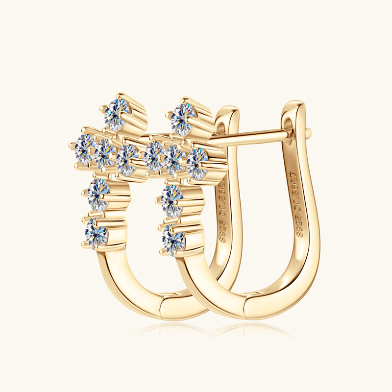 Detailed close-up of sterling silver huggie earrings showcasing moissanite stone setting and craftsmanship
