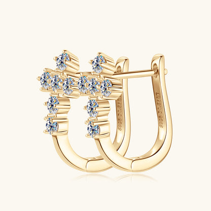 Detailed close-up of sterling silver huggie earrings showcasing moissanite stone setting and craftsmanship