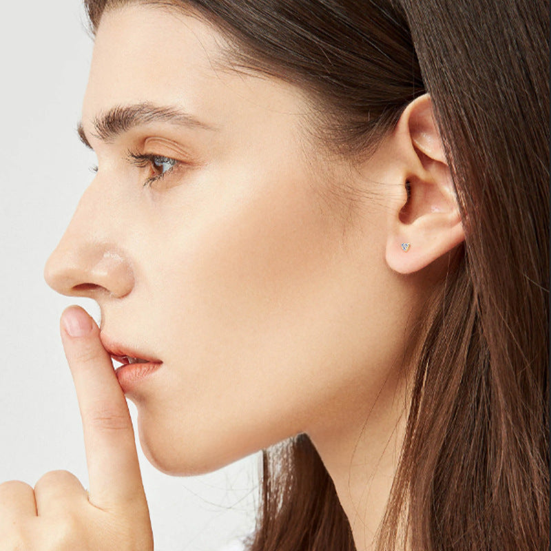 Woman wearing 14K gold heart stud earrings lifestyle