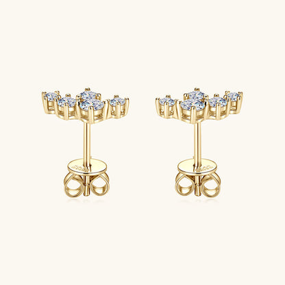 Size reference comparison of 14K gold star-shaped moissanite stud earrings demonstrating elegant proportions