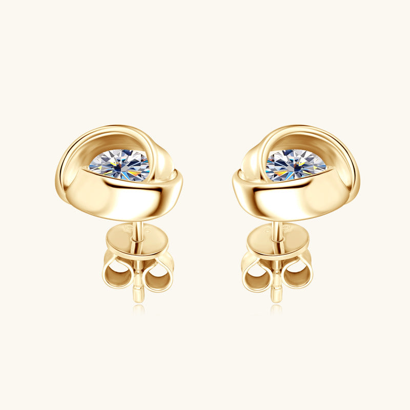 Sterling silver flower stud earring resting on soft surface showing size