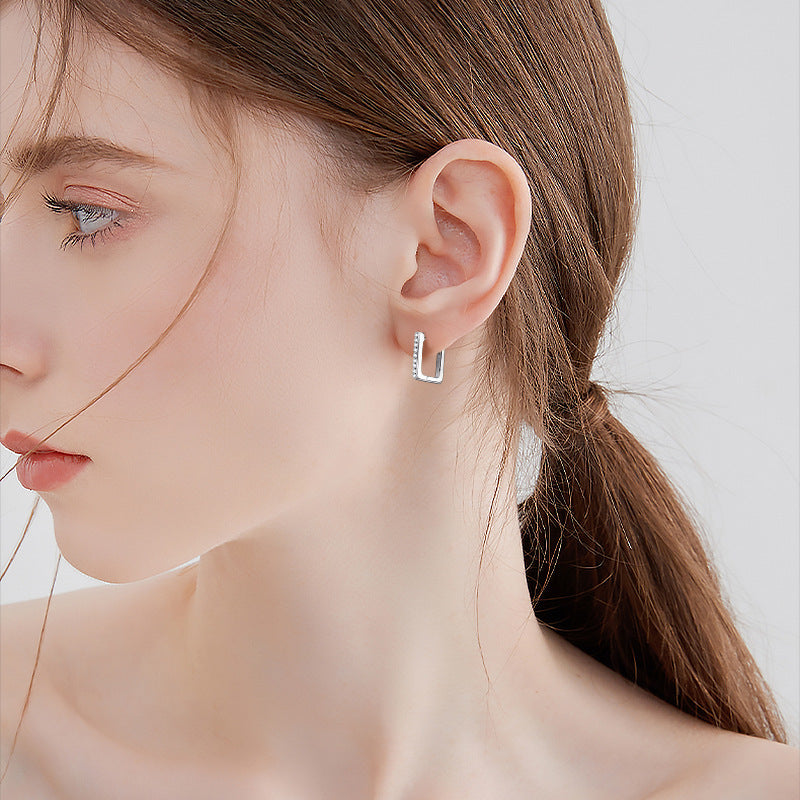 Elegant stud earrings on plain surface showing design
