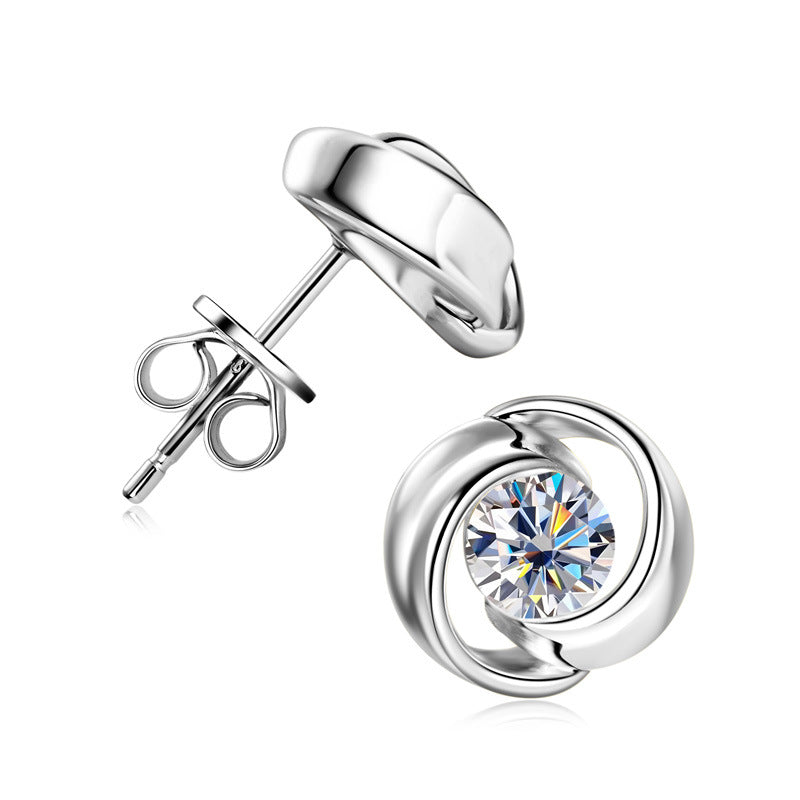 Delicate flower shaped earring with silver metalwork and centered stone