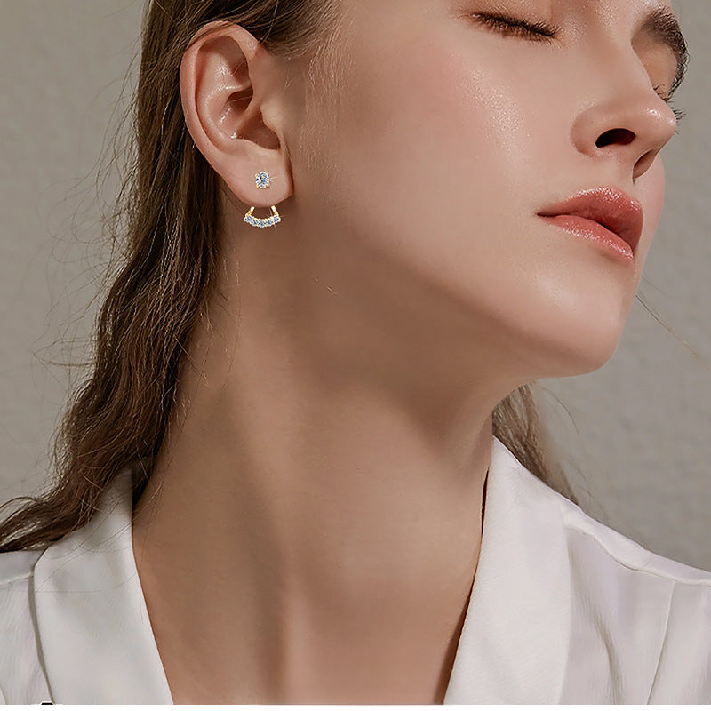 Butterfly earrings hanging with light reflecting from stones