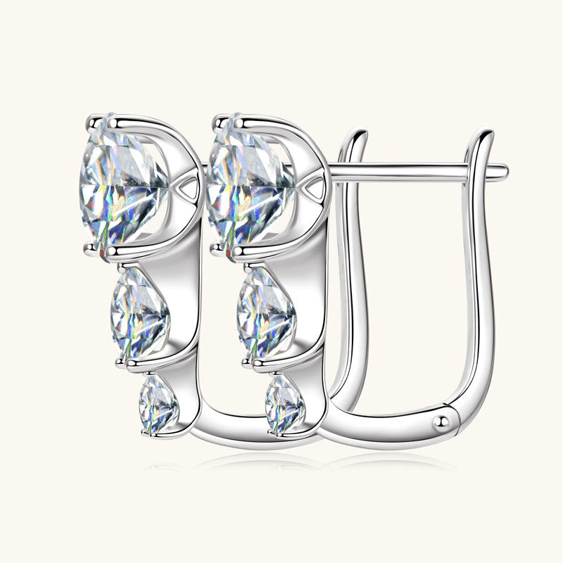 Side profile of huggie earrings showing silver curve and stone