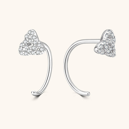 Brilliance and fire display of contemporary C shaped moissanite stud earrings in natural light