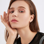 Angle shot of Luckinging Cross Stud Earrings displaying sparkle and craftsmanship