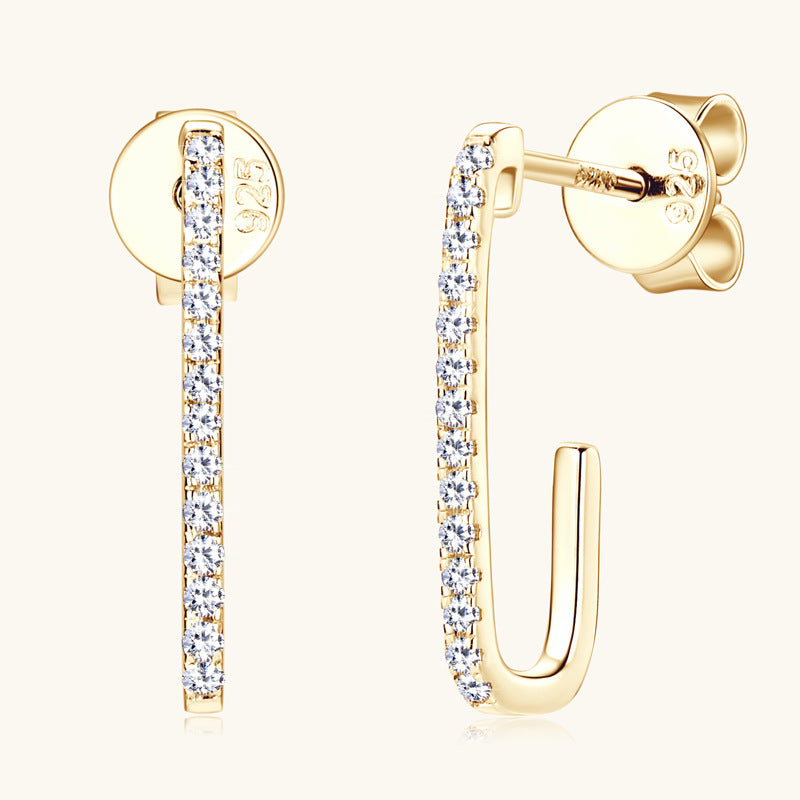Gold dangle earrings with moissanite stones