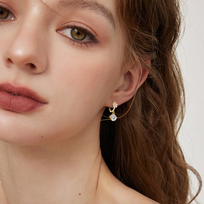 Model wearing floral dangle earrings showing how they frame the face