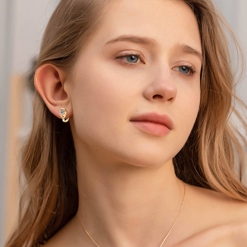 Delicate huggie earrings worn in professional setting