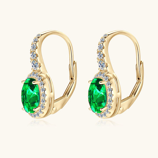 Sterling silver emerald huggie earrings front view showing brilliant oval cut green stones
