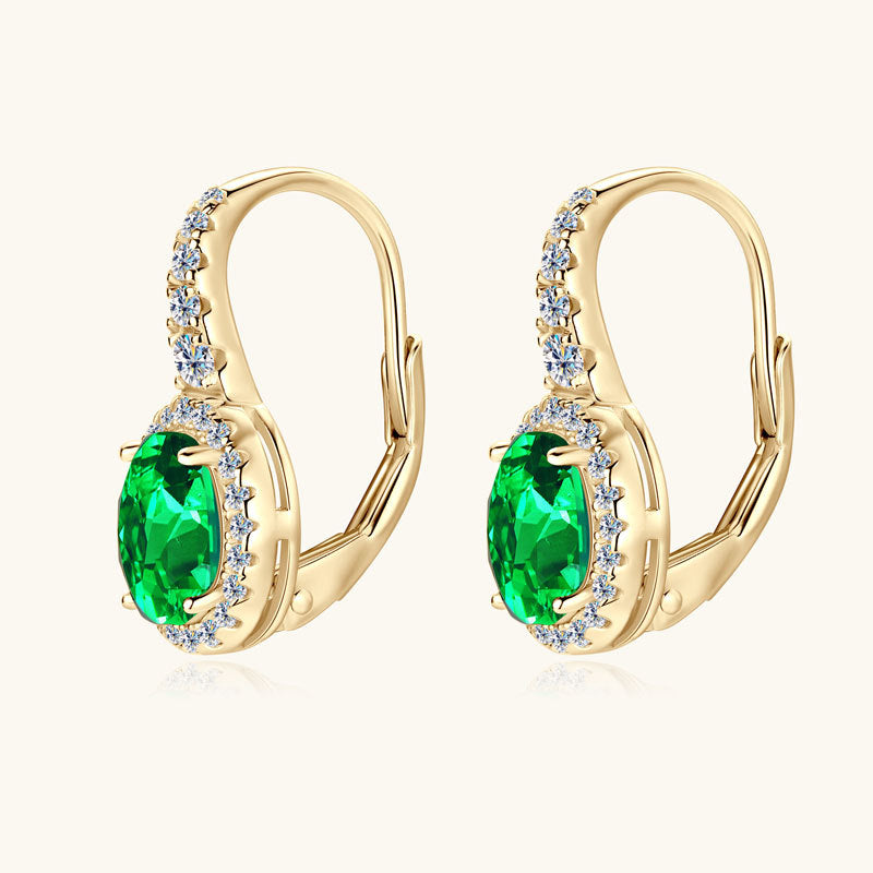 Front view of emerald huggie earrings with zirconia halo