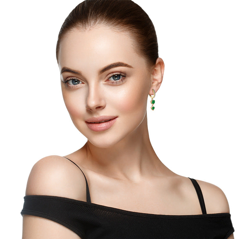 Side view of lightweight emerald dangle earrings