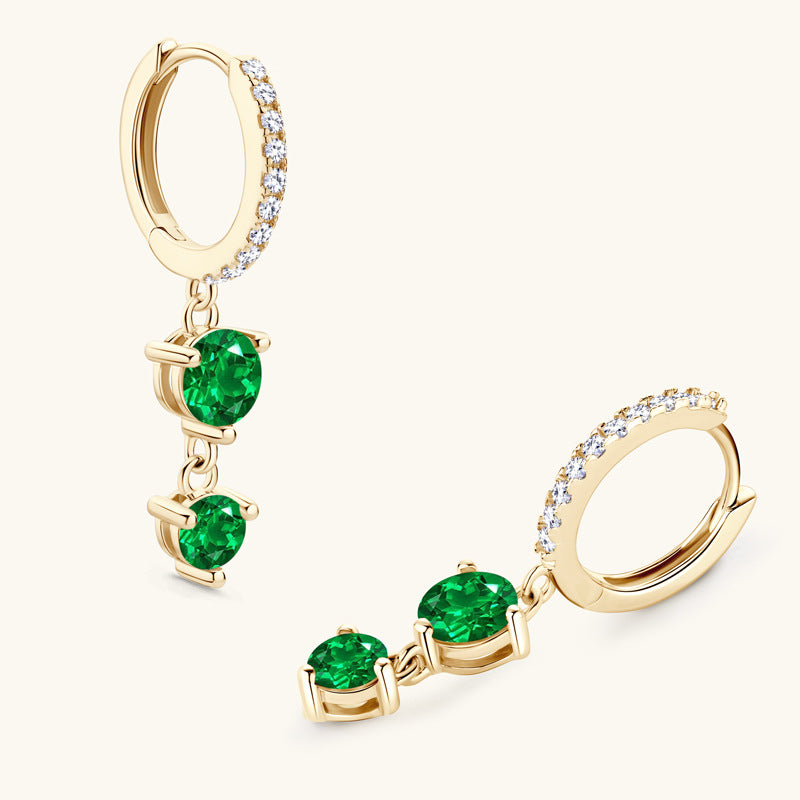 Elegant emerald and silver earring on model