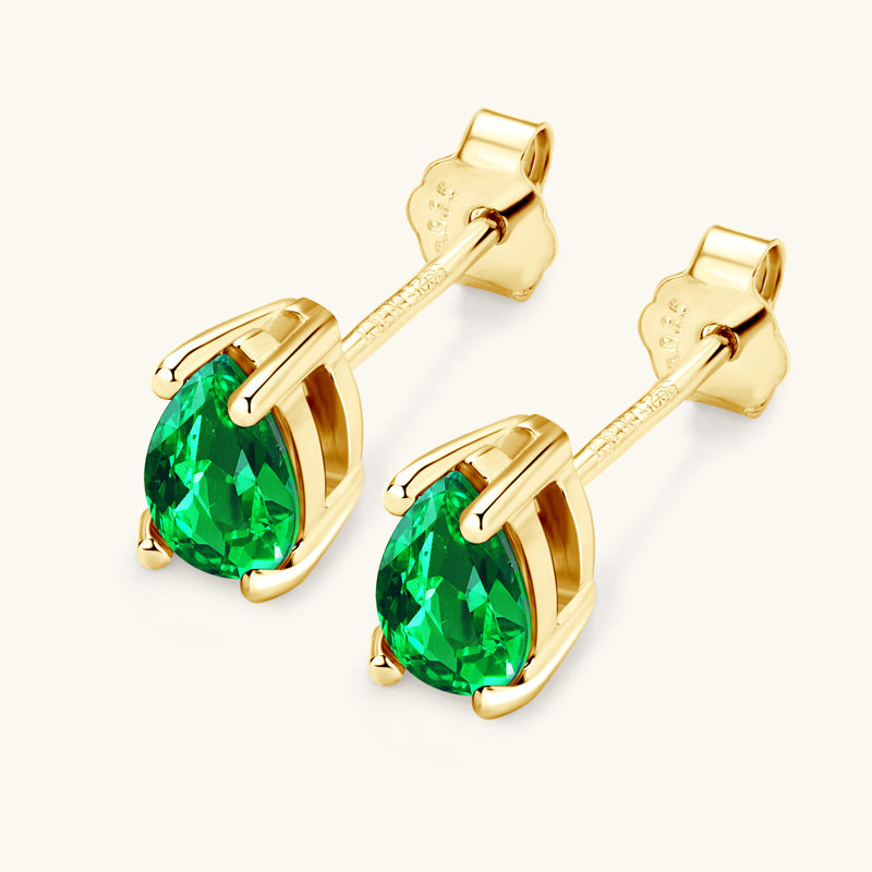 Elegant emerald drop earrings on model