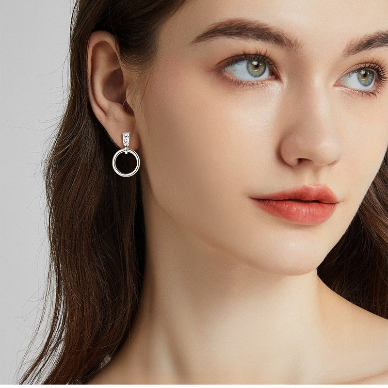 Side profile of gold hoop dangle earrings showing drop design