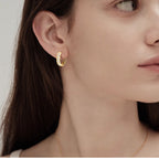 Side view of lightweight gold hoop earrings on ear