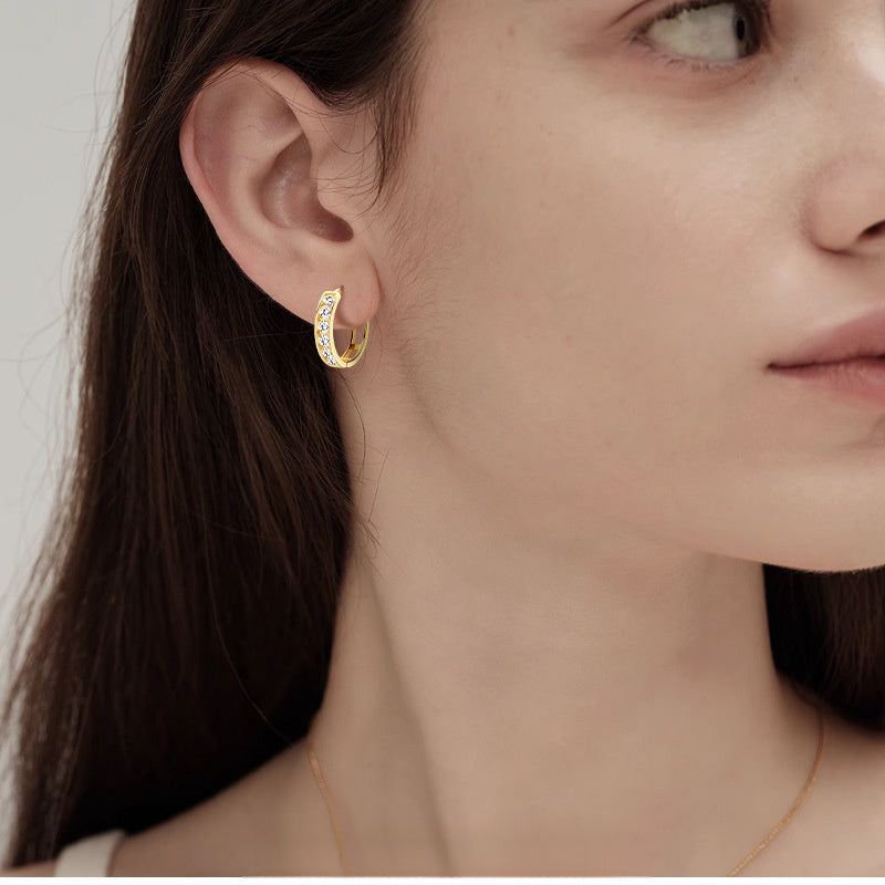 Side view of lightweight gold hoop earrings on ear