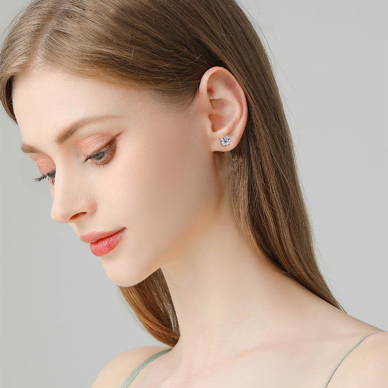 Pair of small gold huggie hoops on white background showing size and proportions