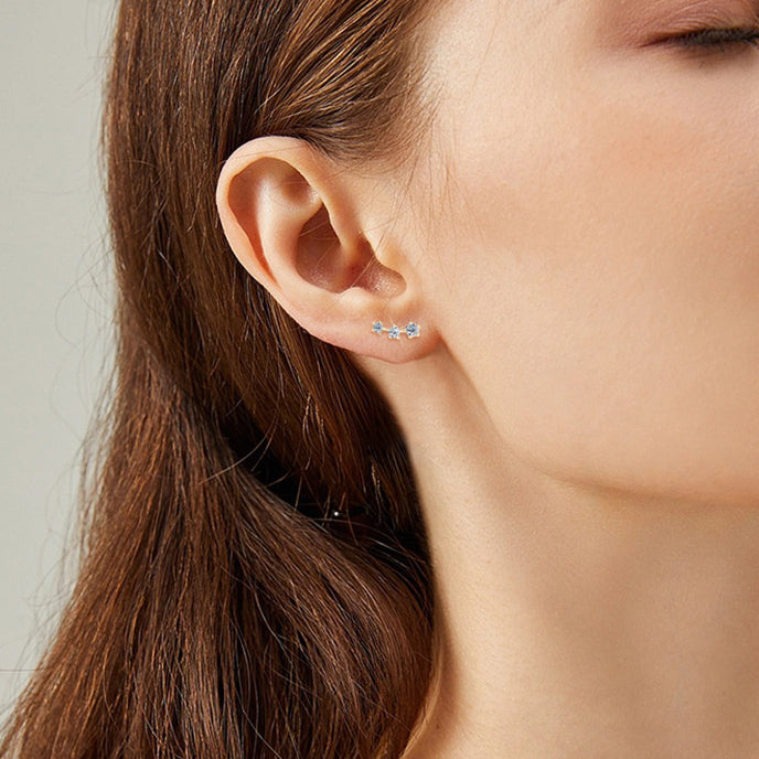 Display of gold star stud earrings pair showing design symmetry