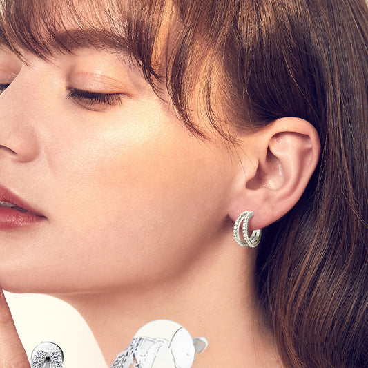 Side profile view of gold stud earrings demonstrating flat back comfort technology for extended daily wear