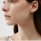 Elegant teardrop moissanite stud earring in 10K gold setting