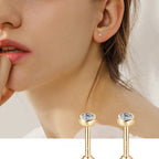 Closeup of gold earring with teardrop gemstone and flat back post