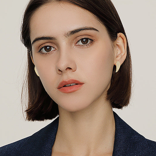 Comfortable fit demonstration of huggie hoop earrings showing secure closure and ergonomic design for all-day wear