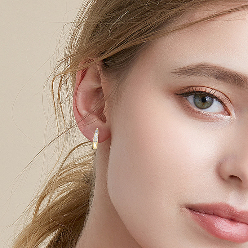 Huggie earrings viewed from below showing dangle effect