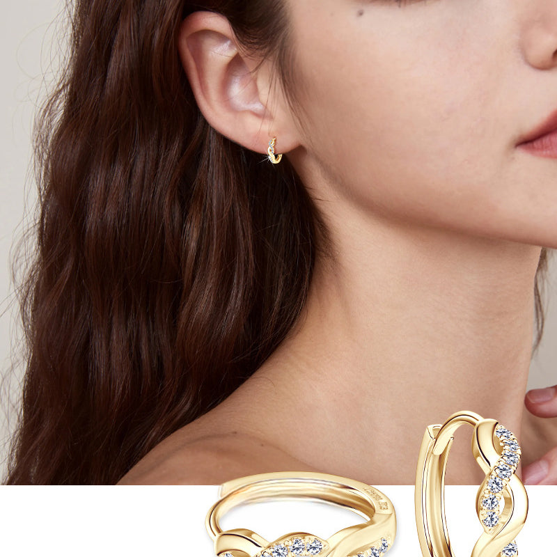 Profile view of spiral huggie earring on model ear