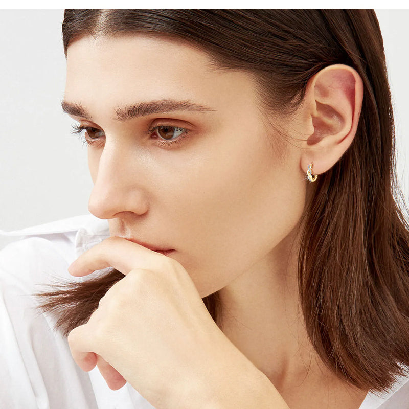 Gold and silver tone huggie earring with stone detail