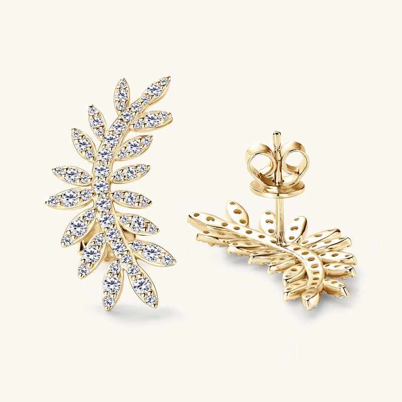 Close-up of leaf design moissanite dangle earrings showing silver setting