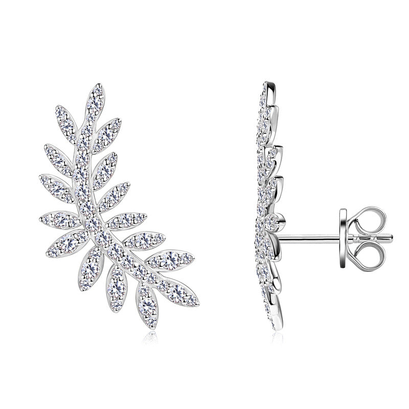 Profile view of leaf-shaped moissanite dangle earrings on model ear
