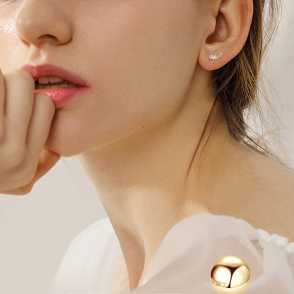 Woman wearing luxury gold flower drop earrings for special occasion styling