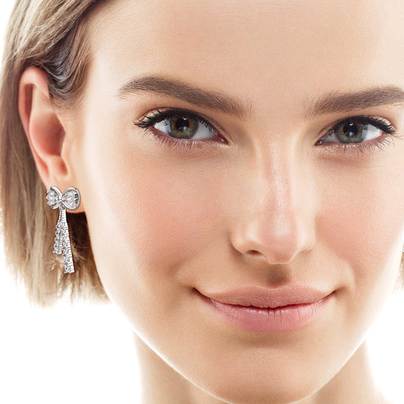 Image of Luckinging bow stud earrings on soft background