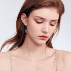 Brilliant moissanite pendant in Luckinging dangle earrings catching the light