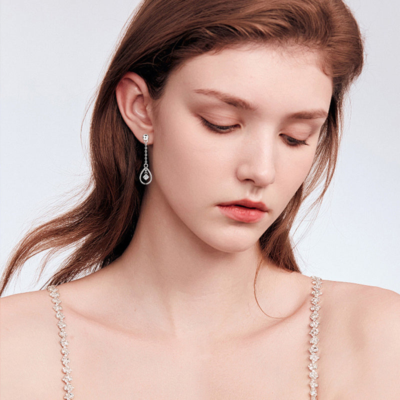 Brilliant moissanite pendant in Luckinging dangle earrings catching the light