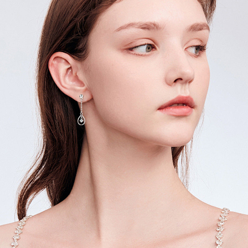 Glimmering detail of the small moissanite in Luckinging dainty drop earrings