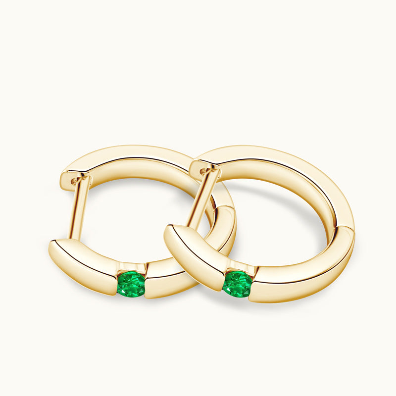 Image of the emerald stone centerpiece in the huggie hoop