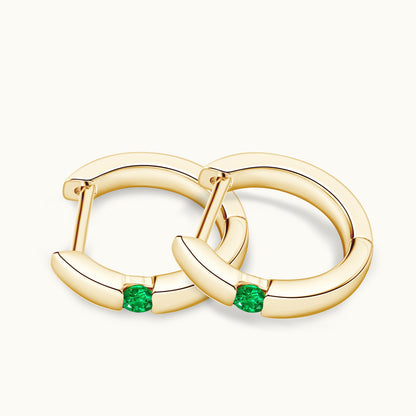Image of the emerald stone centerpiece in the huggie hoop
