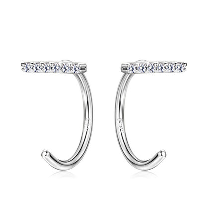 Professional woman wearing 14K gold stud earrings at work