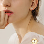 Gold Flower Drop Earrings resting on white background
