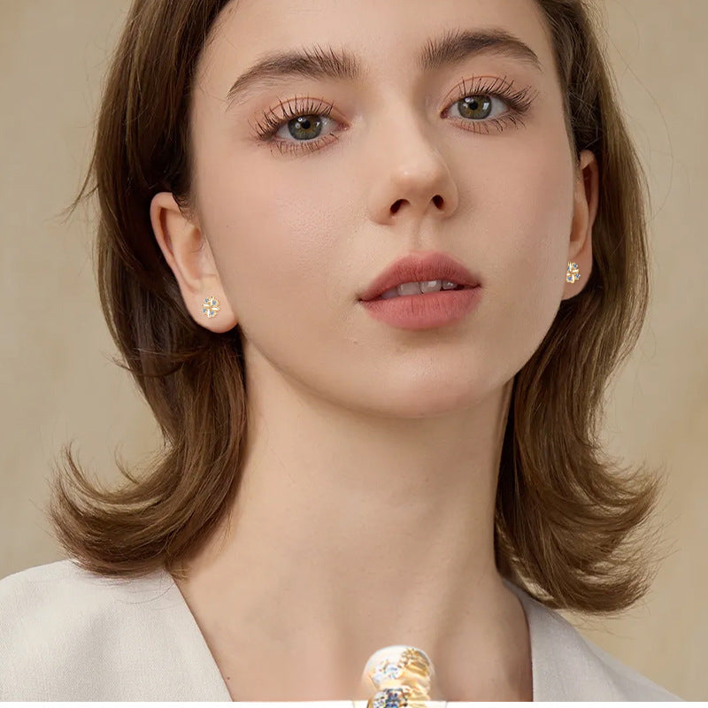 Close-up of four-leaf clover design huggie earring with sparkle