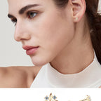 Side view of gold huggie stud with delicate leaf detail