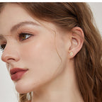 Earring showcasing alternating four-leaf clover and moissanite