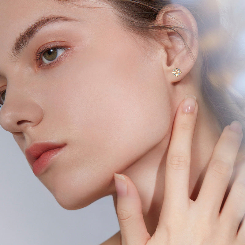 Minimalist gold huggie earring worn on ear