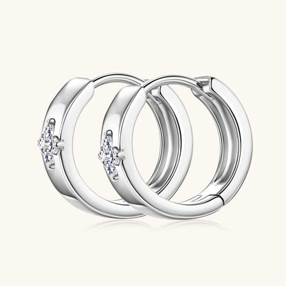 Side profile view of gold huggie hoop earrings showing thickness and curve