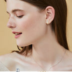Close-up detail of moissanite stones set in Luckinging hoop earrings