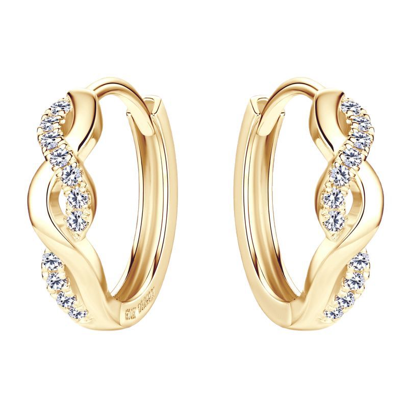 Light reflection on spiral huggie earrings showing moissanite fire and sterling silver polish quality